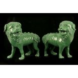 A PAIR OF GREEN GLAZED LIONS.
Qing Dynasty.
Standing four square with open mouths the bodies covered