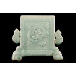 A CHINESE LONGQUAN CELADON TABLE SCREEN.
Ming Dynasty.
Of rectangular form with cloud-form ears, one