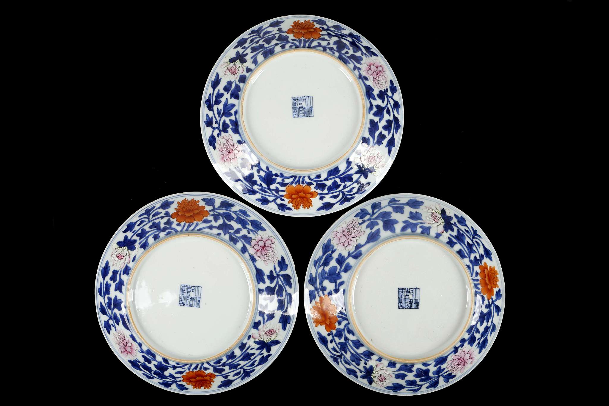 A SET OF THREE CHINESE ENAMELLED BLUE AND WHITE PLATES.
Qing Dynasty, Qianlong mark and of the