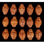 A COLLECTION OF FIFTEEN CARVED NUT BEADS.Each car