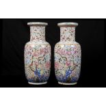 A PAIR OF PINK GROUND HUNDRED BOYS ROULEAU VASES.
Late Qing Dynasty.
Decorated overall with a