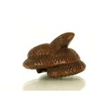 A JAPANESE CARVED WOOD NETSUKE FORMED AS A SNAKE.
Late Meiji, 19th Century.
With the head emerging