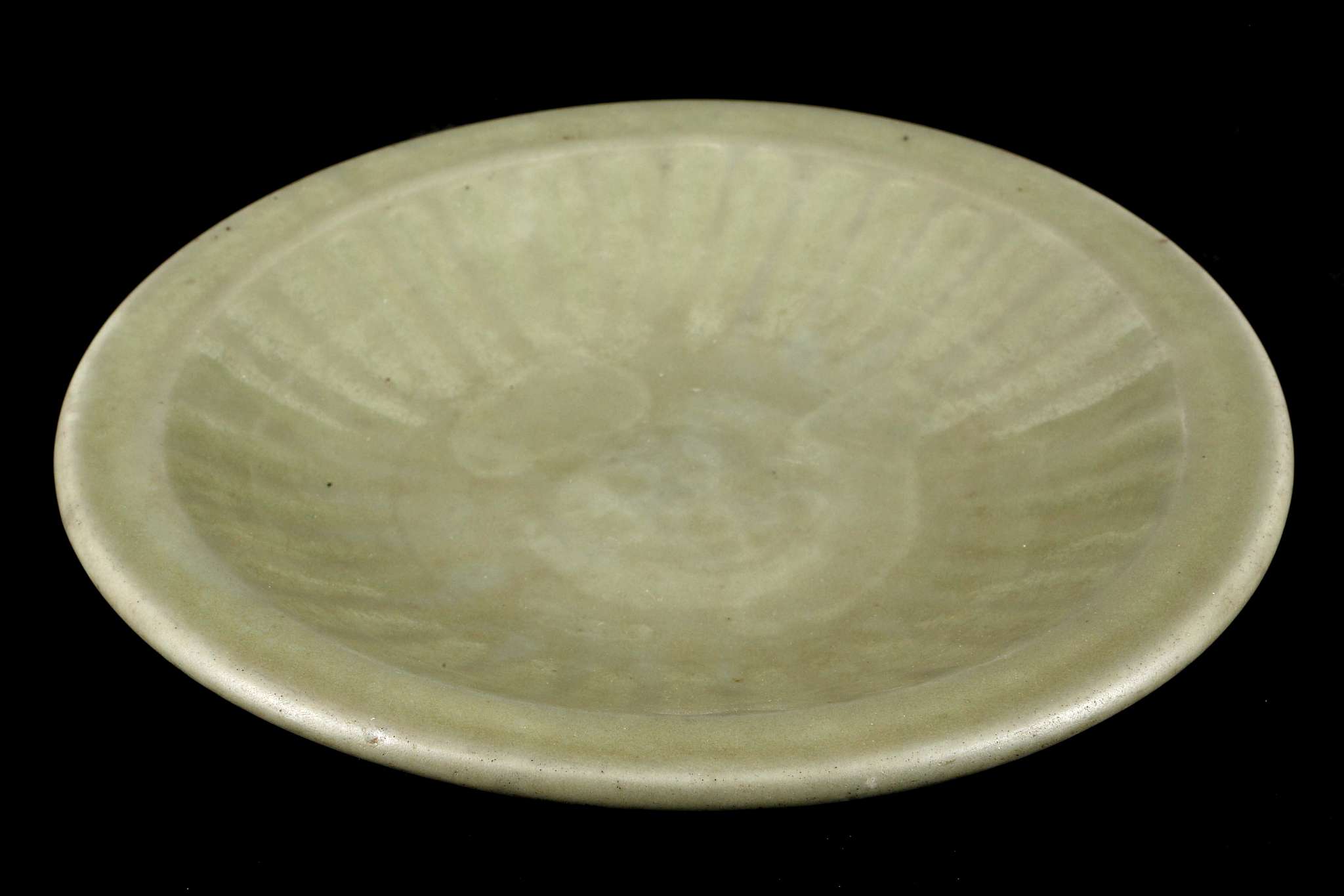 A CHINESE LONGQUAN CELADON CHARGER.
Ming Dynasty.
The interior moulded with ribs, the glaze is of