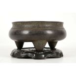 A CHINESE BRONZE TRIPOD CENSER.
17th / 18th Century.
The compressed globular body supported by three