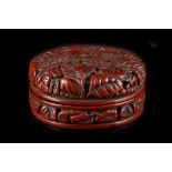 A JAPANESE CINNABAR LACQUER CIRCULAR BOX AND COVER.
18th Century.
The top and sides carved with