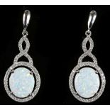 A pair of silver pendant earrings, with white opal