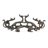 A CHINESE BRONZE ‘QILONG’ BRUSH REST.
Qing Dynasty.
Cast in openwork as four entwined qi dragons,