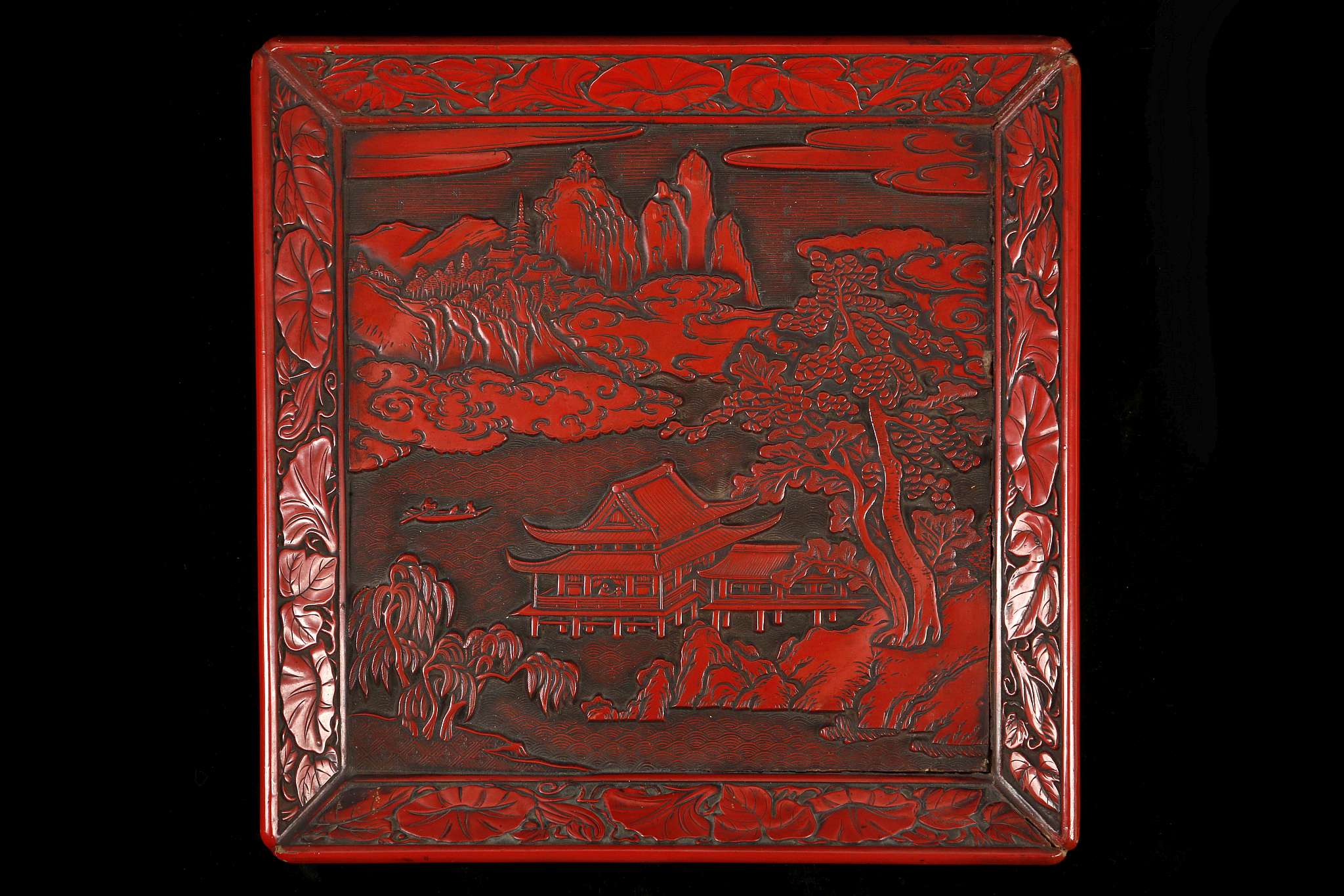 A JAPANESE CARVED CINNABAR LACQUER SQUARE TRAY.
Late Meiji, 19th Century.
Carved with a landscape