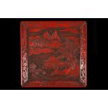 A JAPANESE CARVED CINNABAR LACQUER SQUARE TRAY.
Late Meiji, 19th Century.
Carved with a landscape