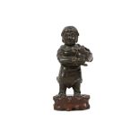 A CHINESE BRONZE FIGURE INCENSE STICK HOLDER.
Ming Dynasty, early 17th Century.
Cast in the form