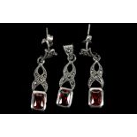 A pair of silver earrings with marcasite and red s