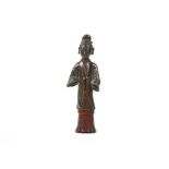 A CHINESE BRONZE FIGURE OF A STANDING LADY.
Ming Dynasty.
Naturalistically cast, the eyes lowered in