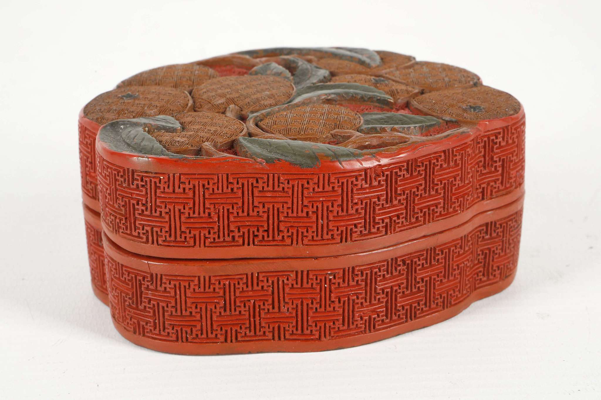 A CHINESE CINNABAR LACQUER LYCHEE BOX AND COVER.
Qing Dynasty, 18th Century.
Carved to the top in