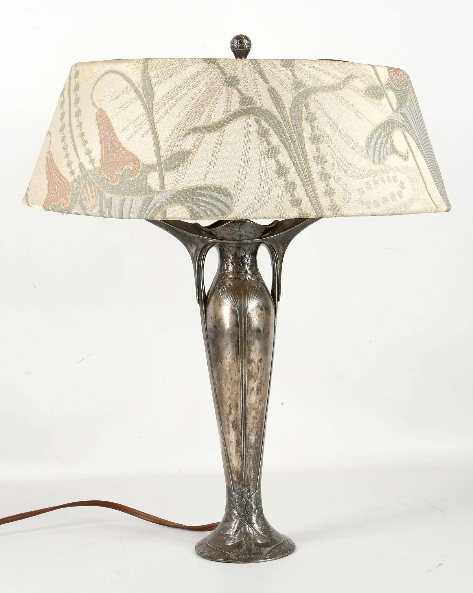 ATTRIBUTED TO OSIRIS, AN ART NOUVEAU PERIOD METAL TABLE LAMP, with embossed decoration, (46cm high)
