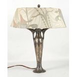 ATTRIBUTED TO OSIRIS, AN ART NOUVEAU PERIOD METAL TABLE LAMP, with embossed decoration, (46cm high)
