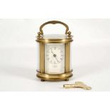 A c.1950's brass and five glass, oval section carriage clock. with white Roman chapter dial, 17