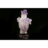 A CARVED AMETHYST VASE AND COVER. 

With attached wooden stand, 14cm H. 

紫水晶雕小花瓶