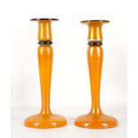 A PAIR OF EARLY 20th CENTURY BOHEMIAN CANDLESTICKS, iridescent tango glass with applied black