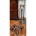 A pair of brass and cast iron fire dogs, a pair of brass two branch wall lights and a brass set of