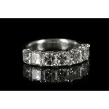 A platinum and diamond 7 stone half eternity ring,