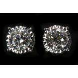 A pair of 18k white gold, screw back diamond stud