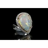 An 18k white gold, tear drop opal cluster ring, op