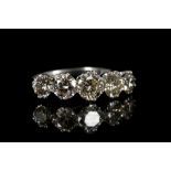 An 18k white gold, graduated 5 stone diamond ring,