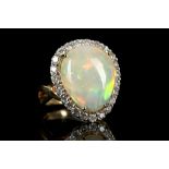 An 18k gold Ethiopian opal and diamond cluster rin