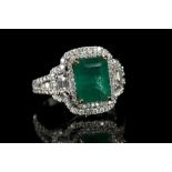 An 18k white gold, Art Deco style, emerald and dia