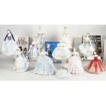 A good collection of nine Royal Doulton figures of ladies in elaborate dresses, including '