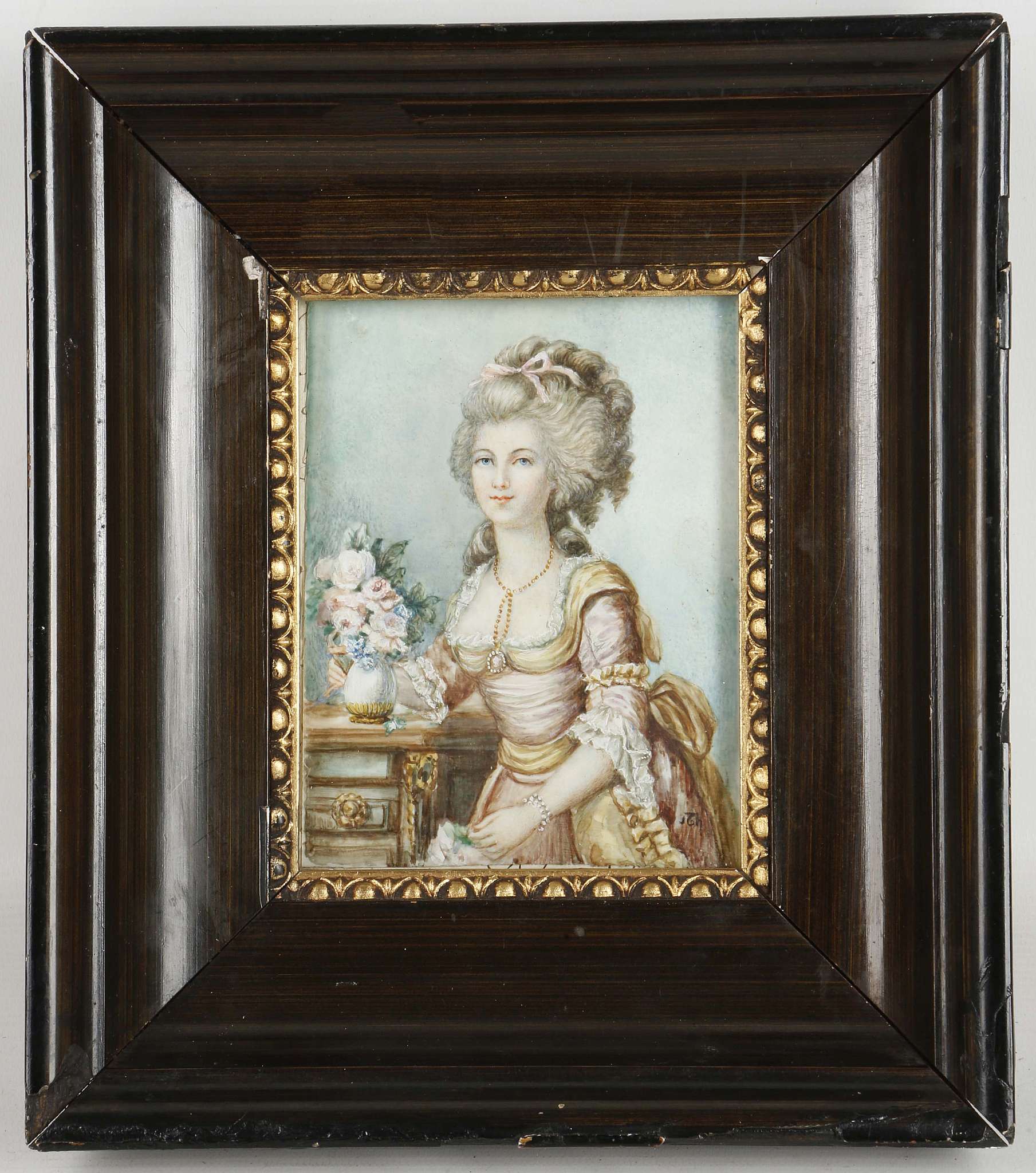 A signed, mounted portrait miniature of a lady in pink dress with a vase of flowers.