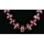 A faceted ruby and crystal bead necklace with silver clasp.