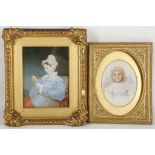 A pair of gilt mounted portrait miniatures, a girl in a lace bonnet and another of an infant. (2).