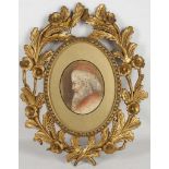 A Grand Tour Italian limewood gilt frame, trailing flowers. An unsigned portrait study of a