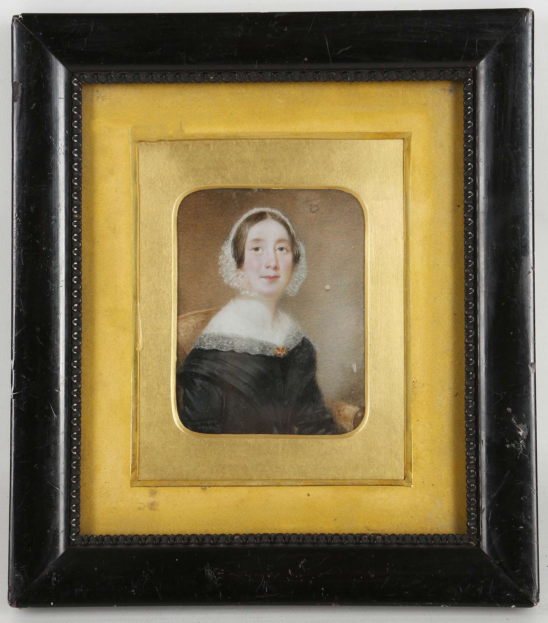 A mounted portrait miniature of a lady in black dress, English, 18th century.