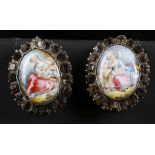 A pair of 19th Century silver and enamel decorated earrings, the romantic portrait plaques framed by