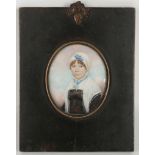 A mounted portrait miniature of a lady in a black dress.