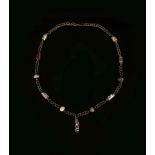 AN EARLY ISLAMIC GLASS BEAD NECKLACE Circa 8th-11th Century A.D. Composed of four core-formed