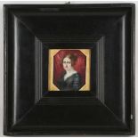 A mounted portrait miniature of a lady in black dress.