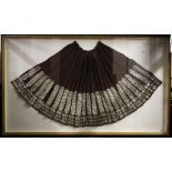 A large early 20th century, Romanian traditional skirt in purple wool with silvered floral