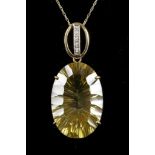 A concave facet lemon citrine held in a pendant shank on a 9ct gold chain.