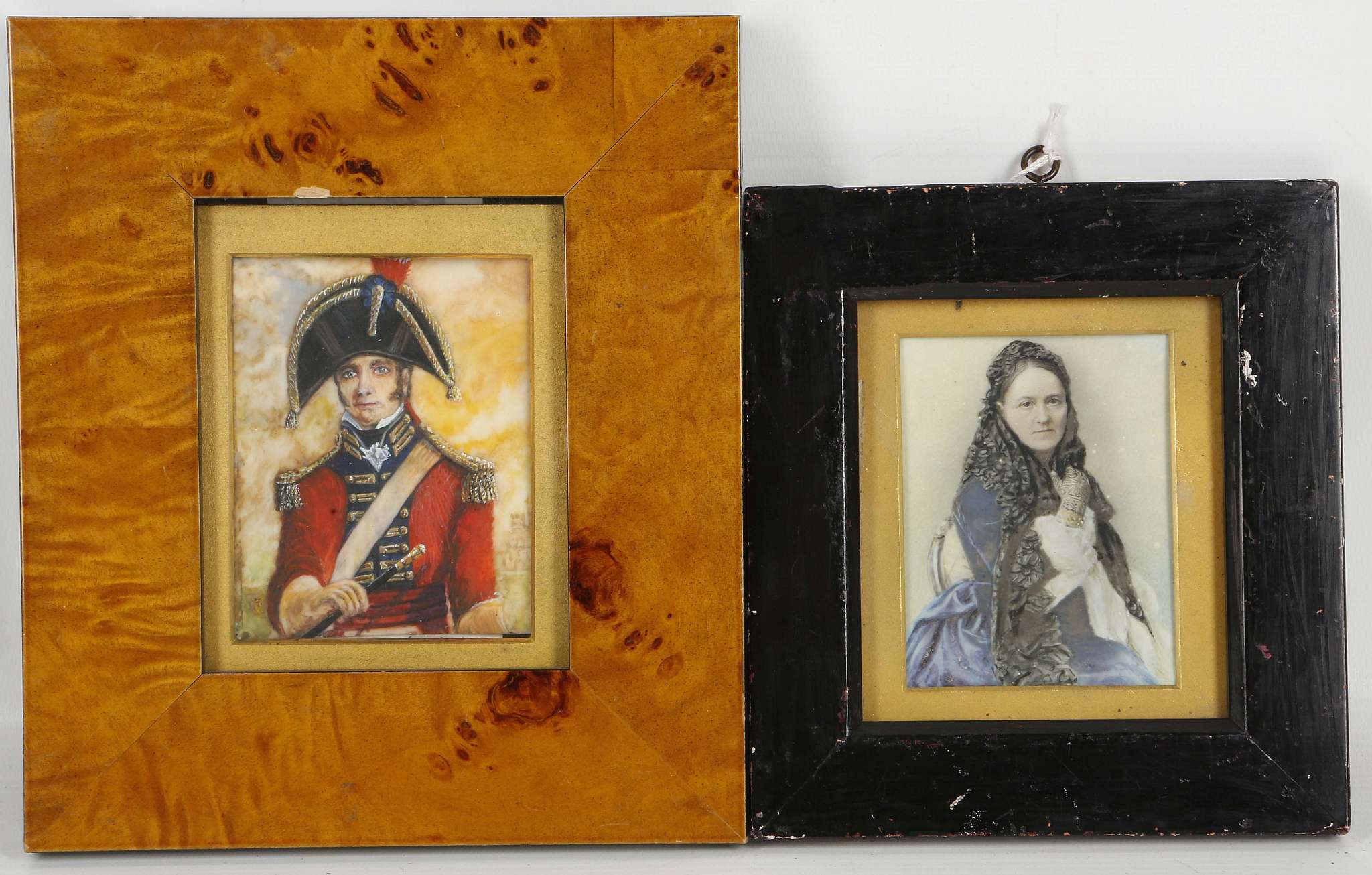 A mounted portrait miniature of a lady in blue and black dress, with another of a military