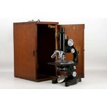 A vintage Ernst Leitz Wetzlar microscope in a mahogany carrying case.