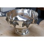 A white metal, Regency style punch bowls with hanging grape decoration.