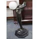 A good bronze figural lamp of an Art Deco nude maiden holding a glass globe, on stepped octagonal
