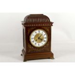 A 19th century mahogany mantle clock having shaped fluted top brass inlay, white enamelled chapter