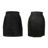 TWO GIANNI VERSACE SKIRTS, both black above the kn