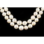A double strand cultured pearl necklace with 14k gold, sapphire and pearl set clasp.