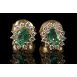 A pair of 18ct yelllow gold, emerald and diamond cluster earrings.