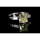 A platinum and diamond engagement ring, centred wi